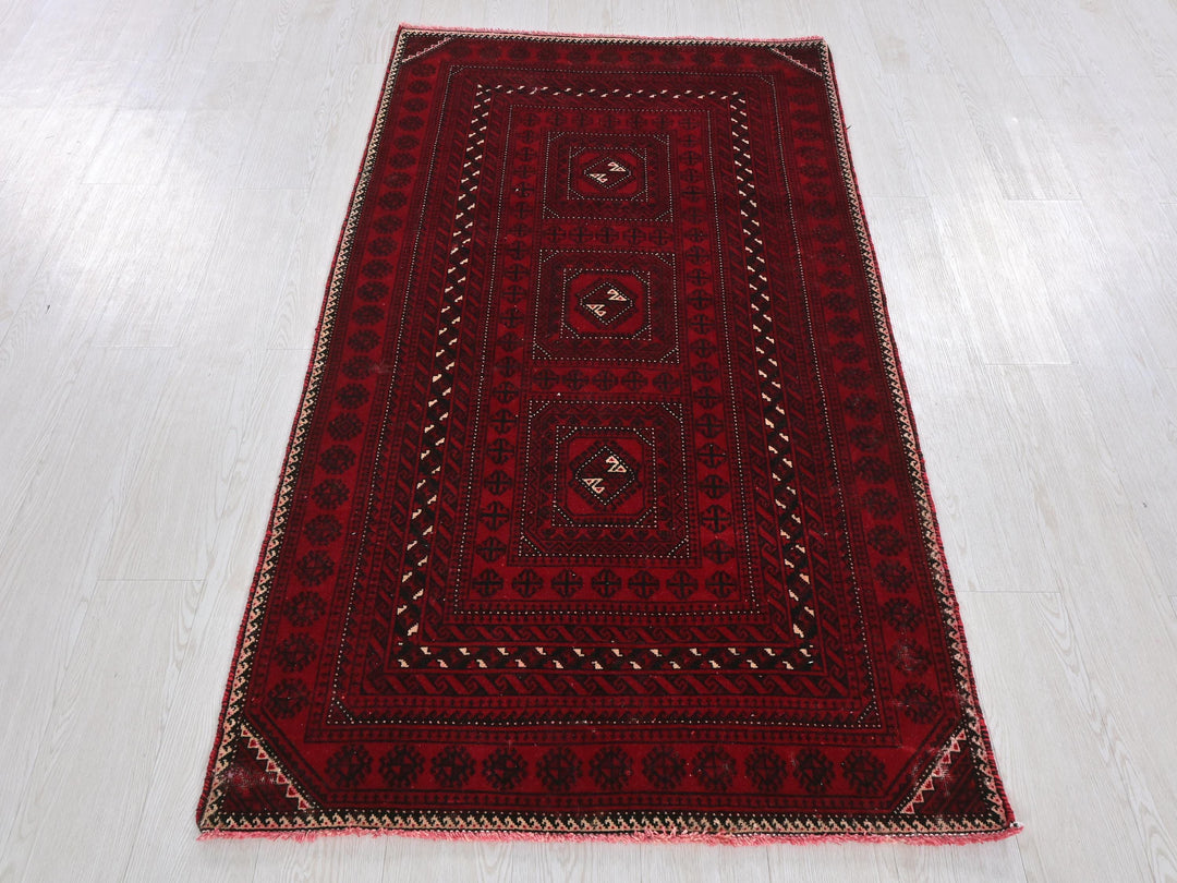 a red rug on a wooden floor with a white floor