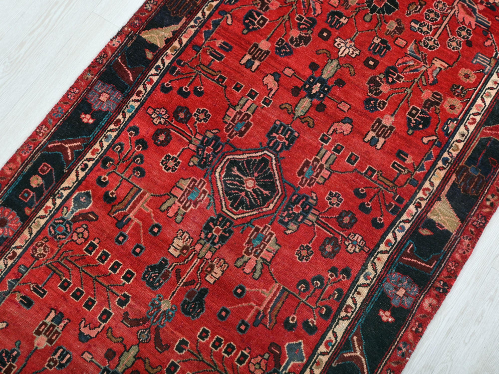 a red rug on a white wooden floor