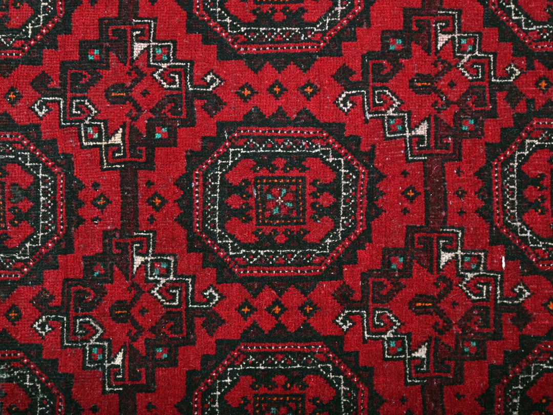 a close up of a red and black rug