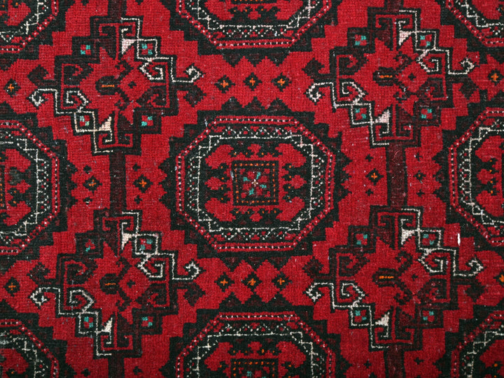 a close up of a red and black rug