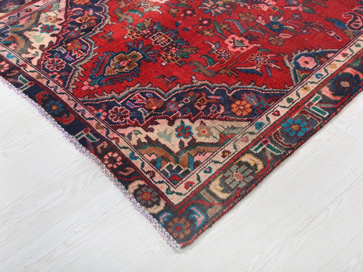 a red oriental rug on a white floor