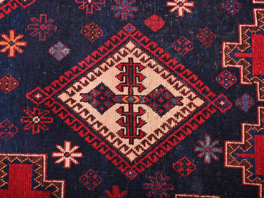 a close up of a blue and red rug