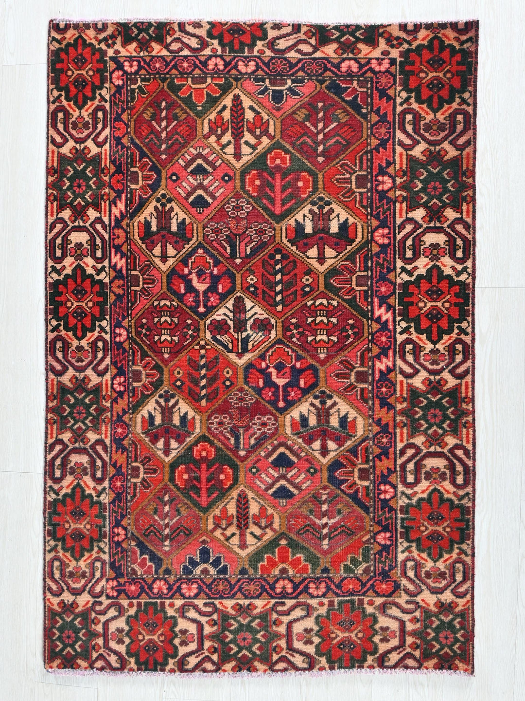 a red and blue rug on a white wall