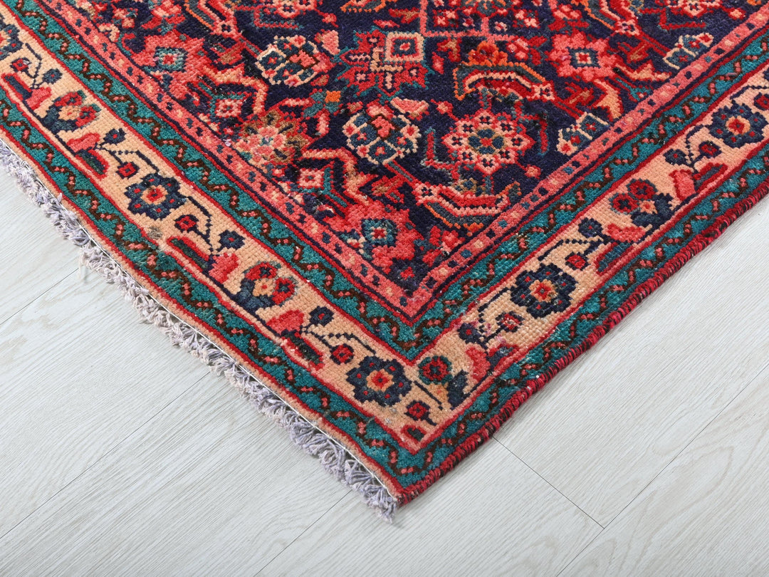 a red and blue oriental rug on a white floor