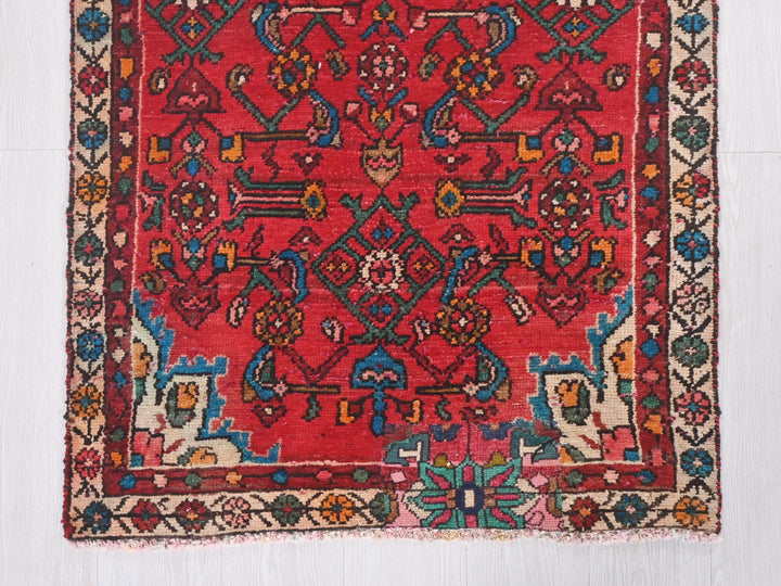 a red rug with a colorful design on it