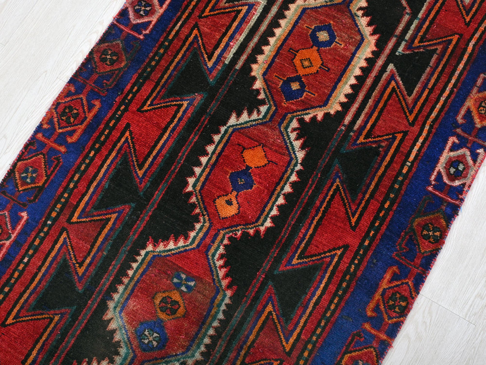 a close up of a colorful rug on a white floor