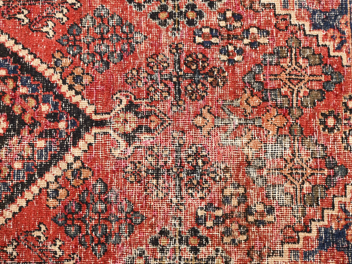a red and blue rug with a pattern on it