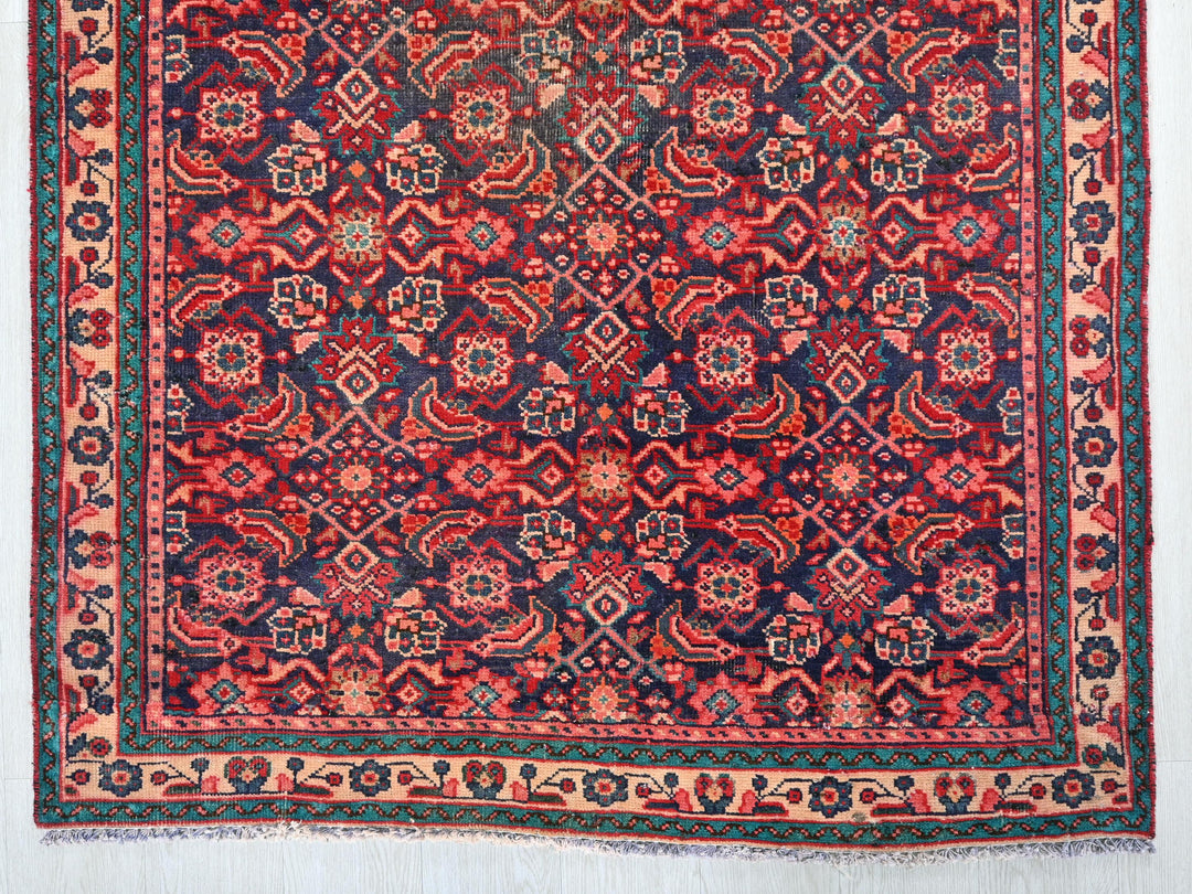 a red, blue, and green rug with a design on it