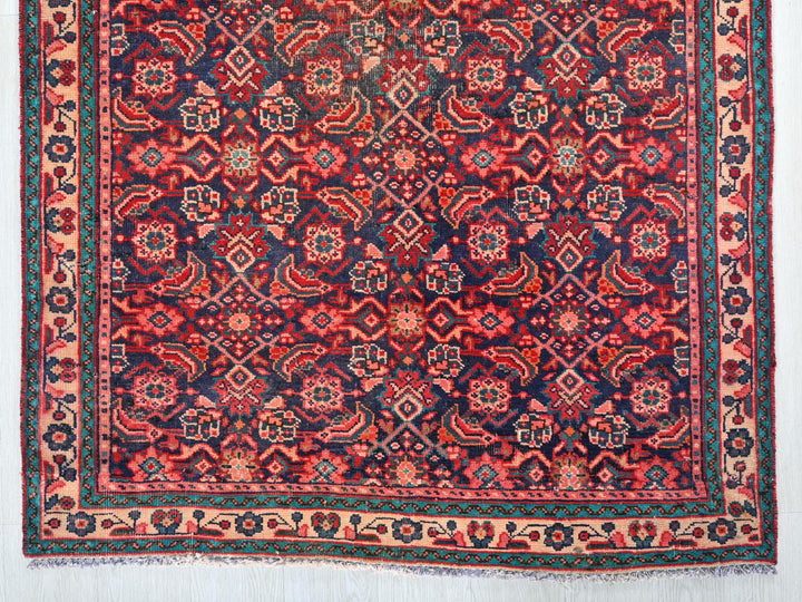 a red, blue, and green rug with a design on it