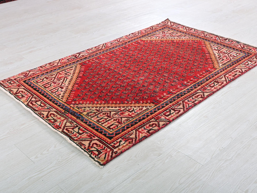 a red rug on the floor of a room
