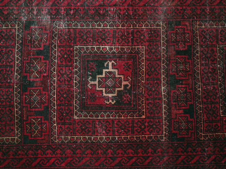a red and black rug with a cross on it