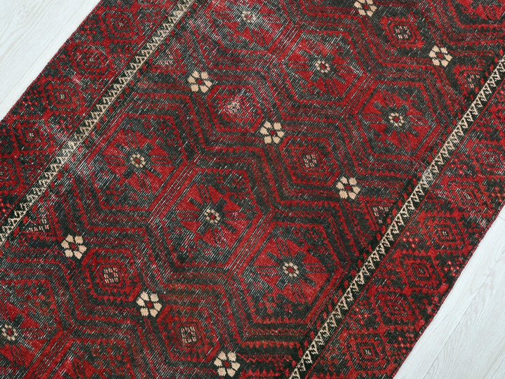 a red rug on a white wooden floor