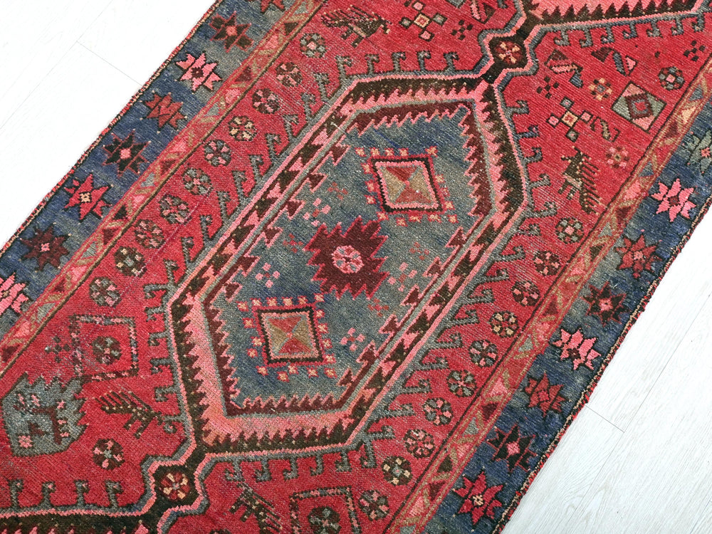 a red and blue oriental rug on a white floor