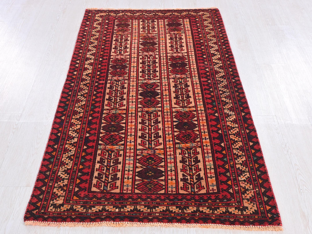 a red and black rug on a white floor