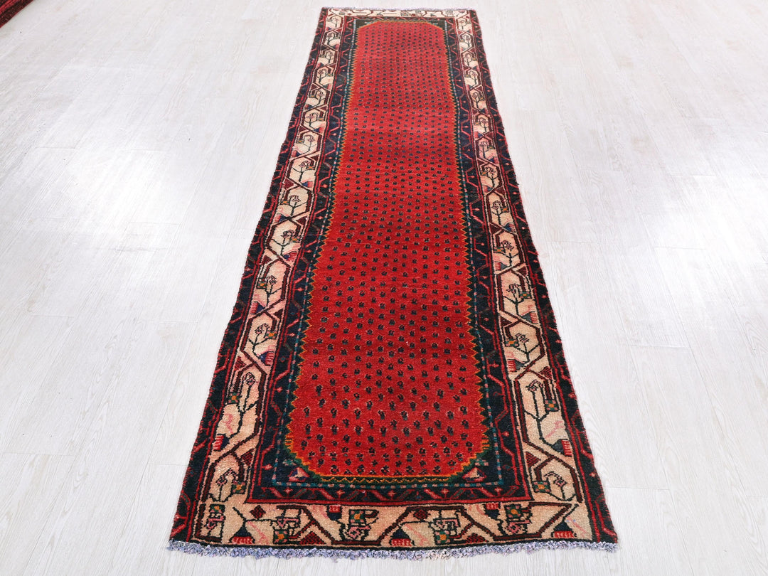 a red runner rug on a white floor