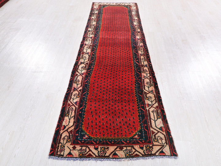 a red runner rug on a white floor