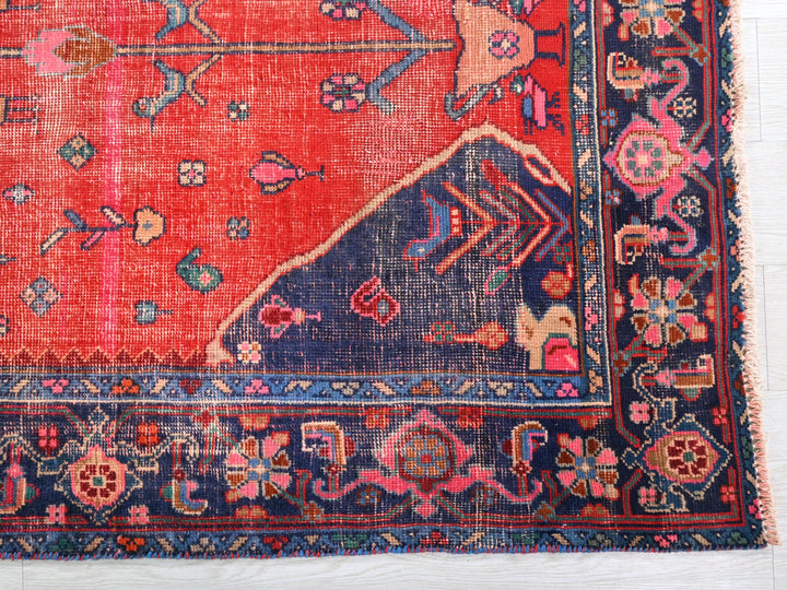 a red rug with blue and pink designs on it