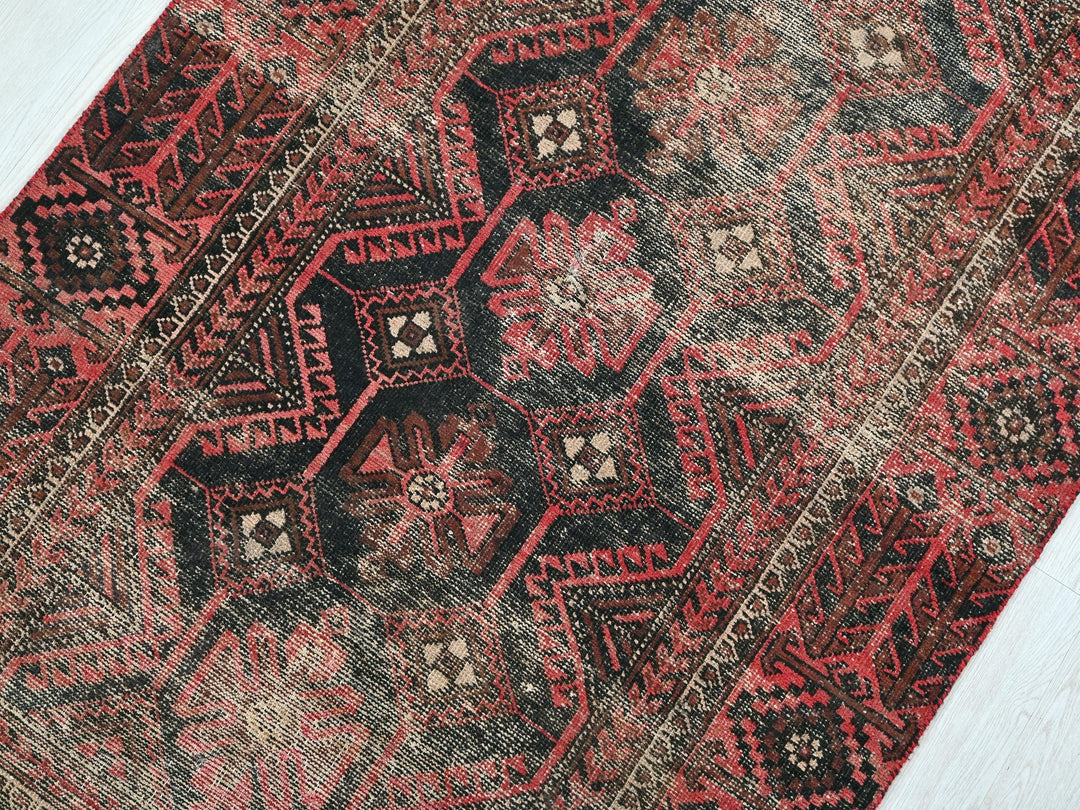 a close up of a red and black oriental rug