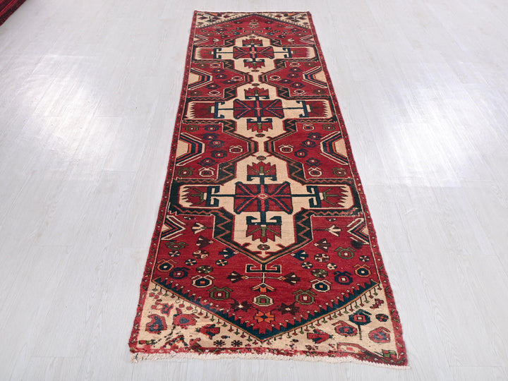 a long red rug on a white floor
