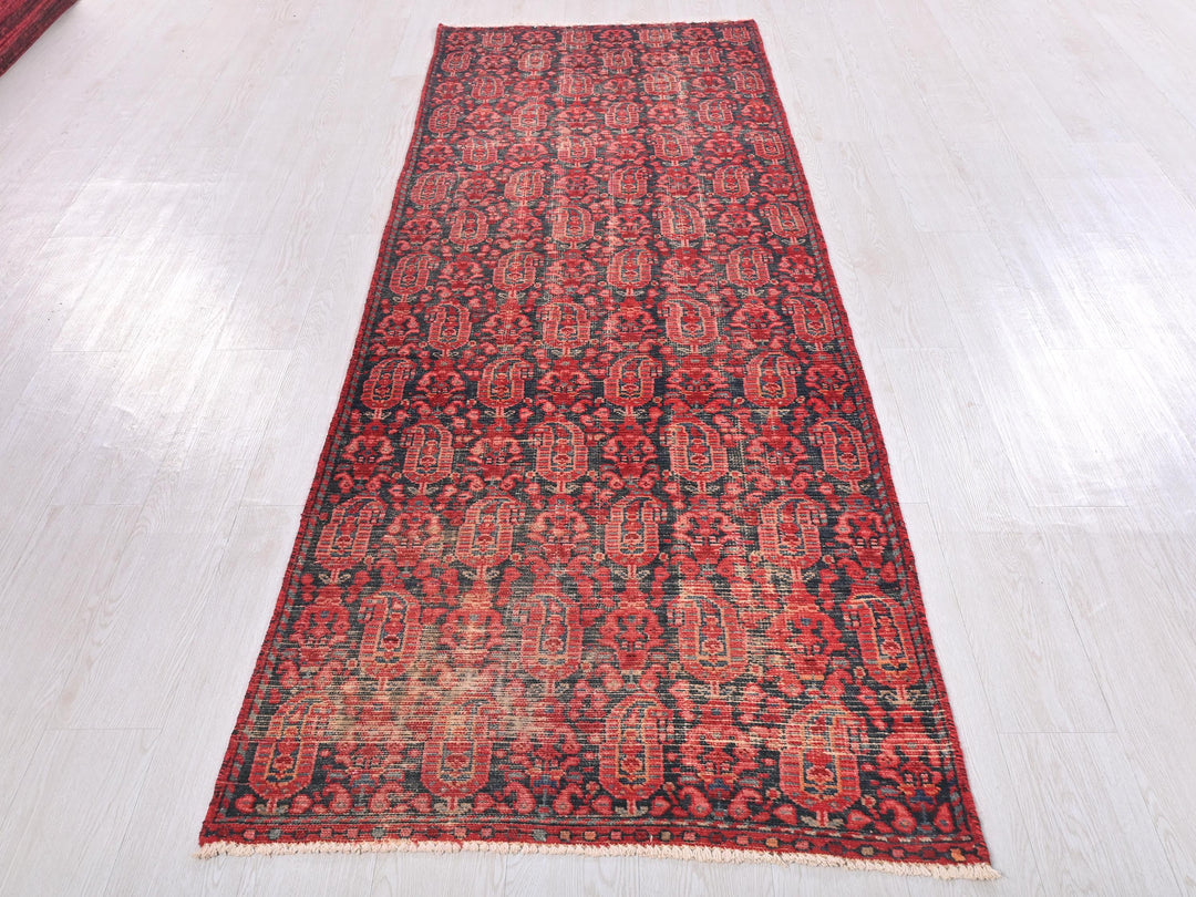 a red rug is laying on a white floor