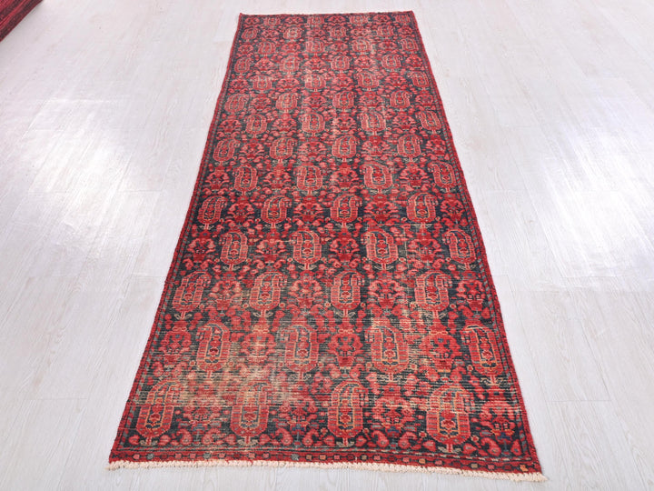 a red rug is laying on a white floor