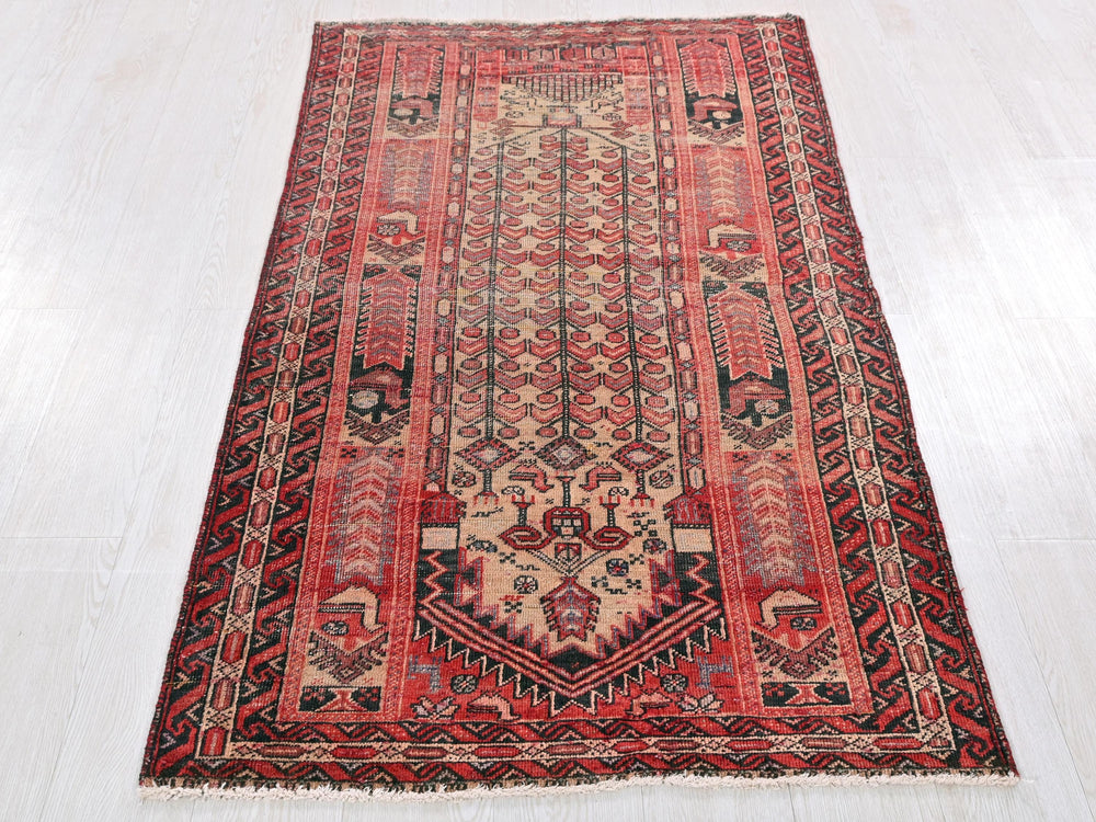 a red and black rug on a white floor