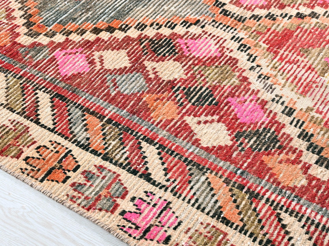 a close up of a rug on a wooden floor