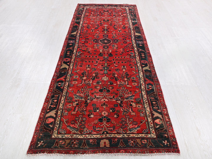 a red rug is laying on a white floor