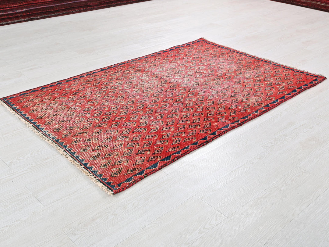 a red rug is laying on the floor