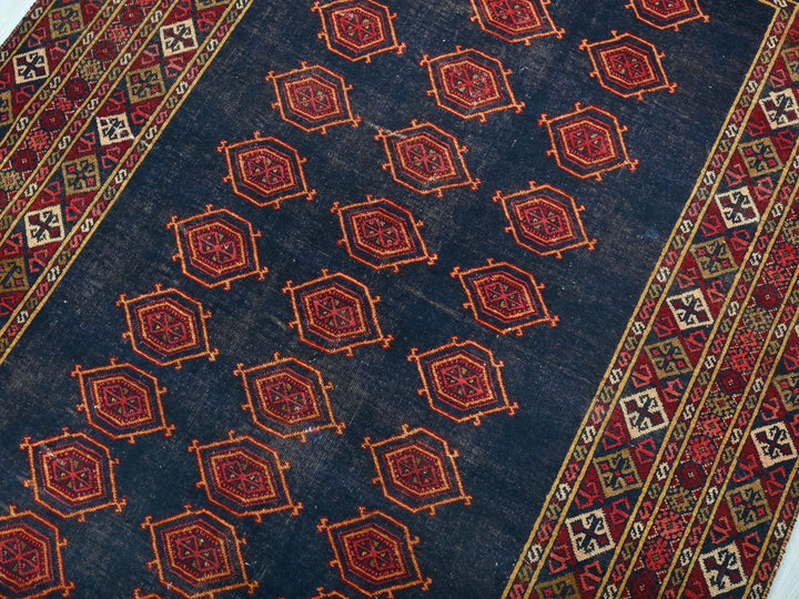 a blue rug with red and yellow designs on it