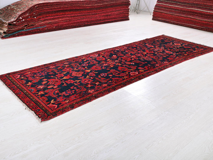 a pile of red rugs sitting on top of a white floor