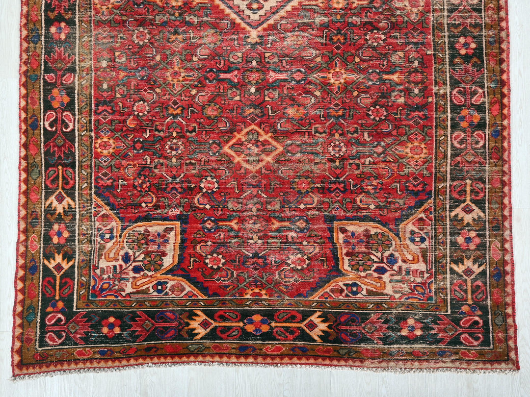 a red and blue rug with a design on it