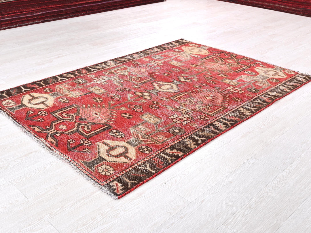 a red rug on the floor of a room