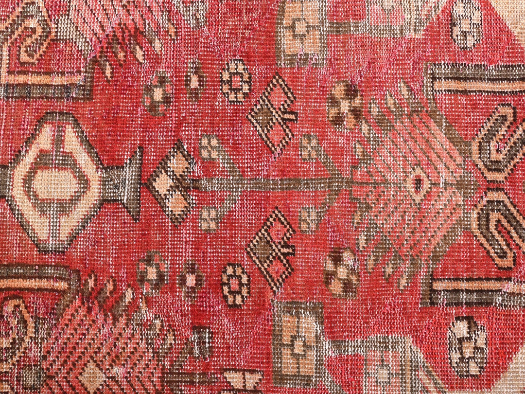 a close up of a red rug with a pattern on it