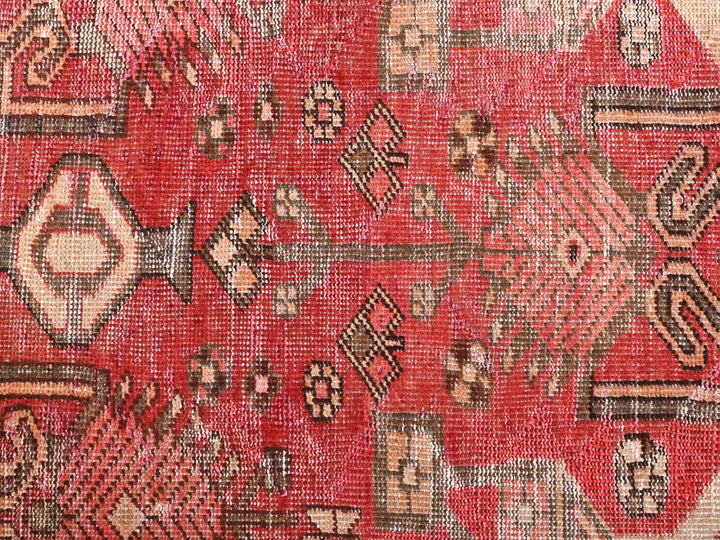 a close up of a red rug with a pattern on it