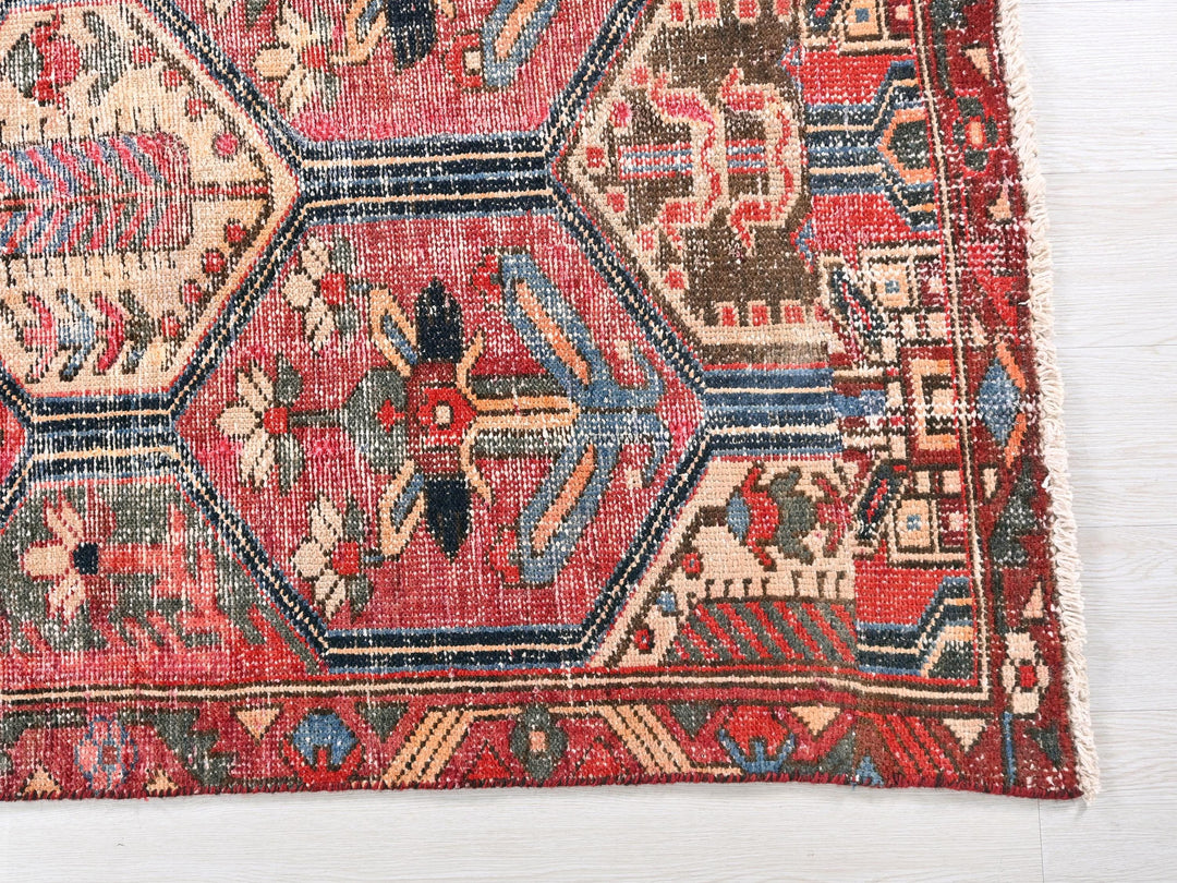a red rug with a pattern on the middle of it