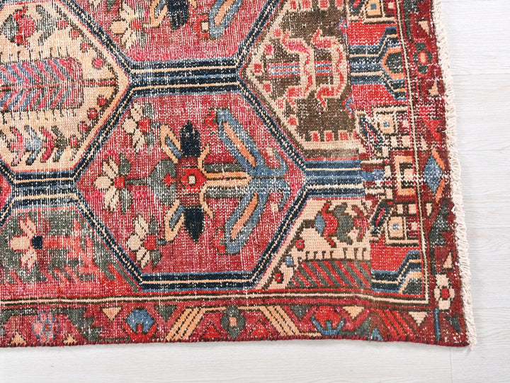 a red rug with a pattern on the middle of it
