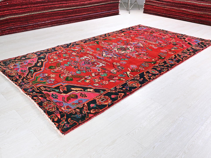 a red oriental rug on a white floor