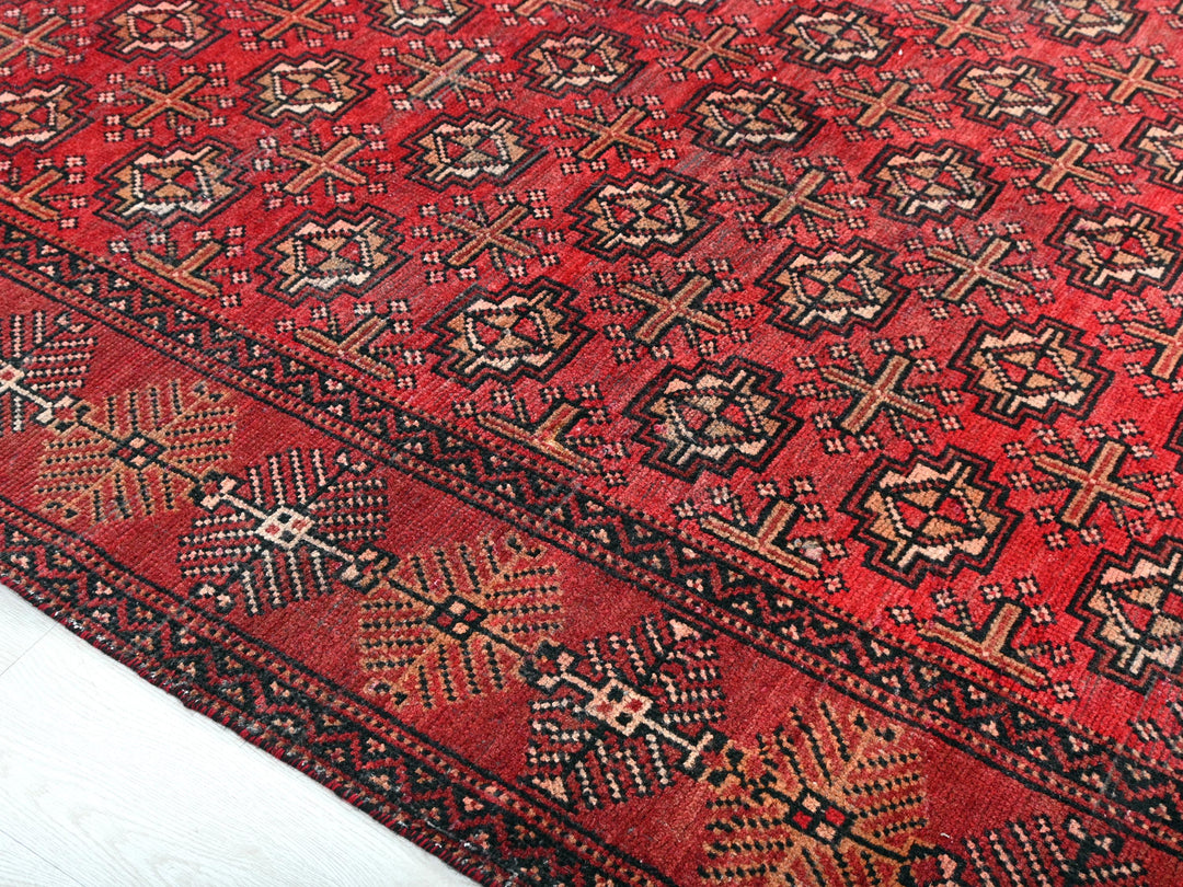 a red rug with a pattern on it
