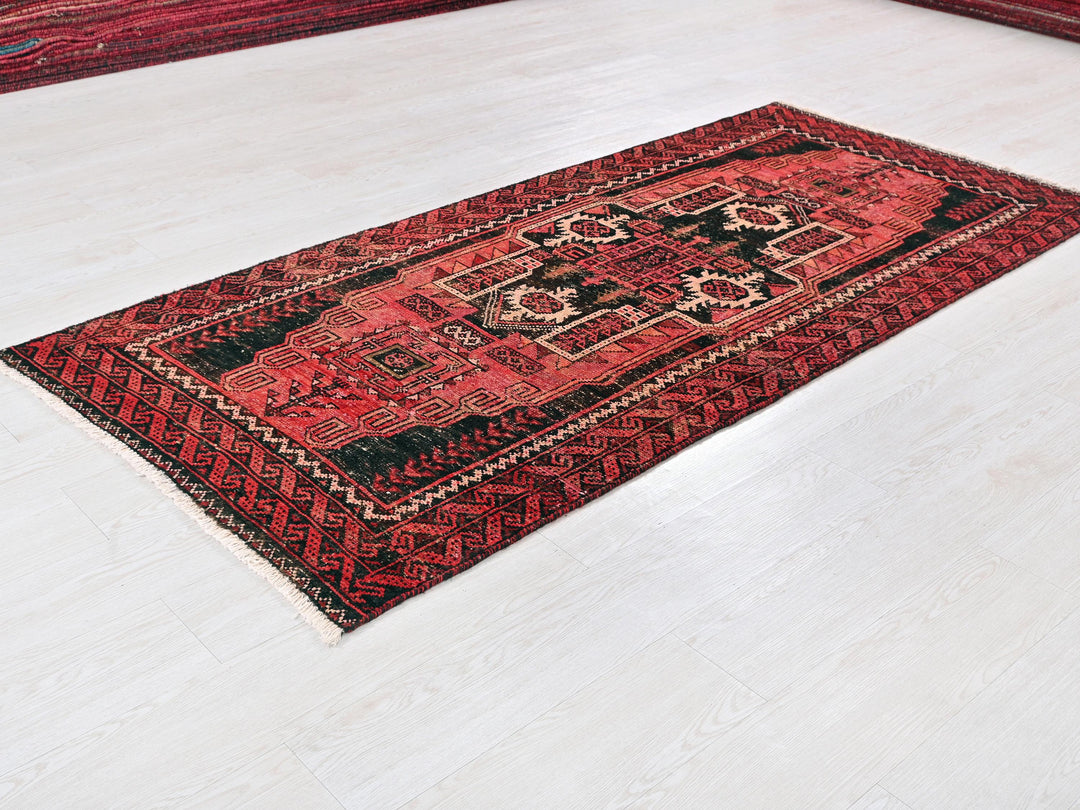 a red rug on the floor of a room