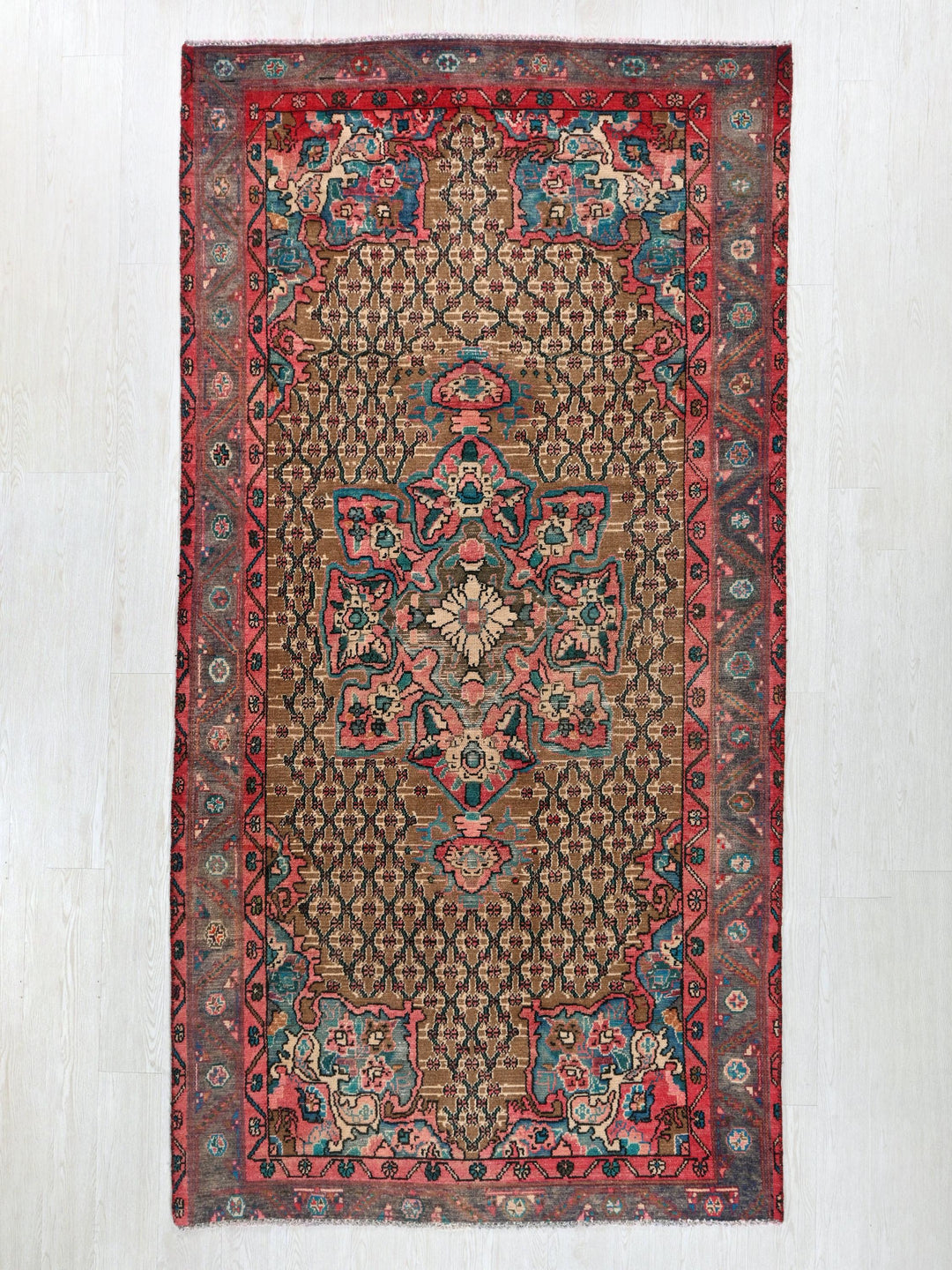 a red and blue rug on a white wall