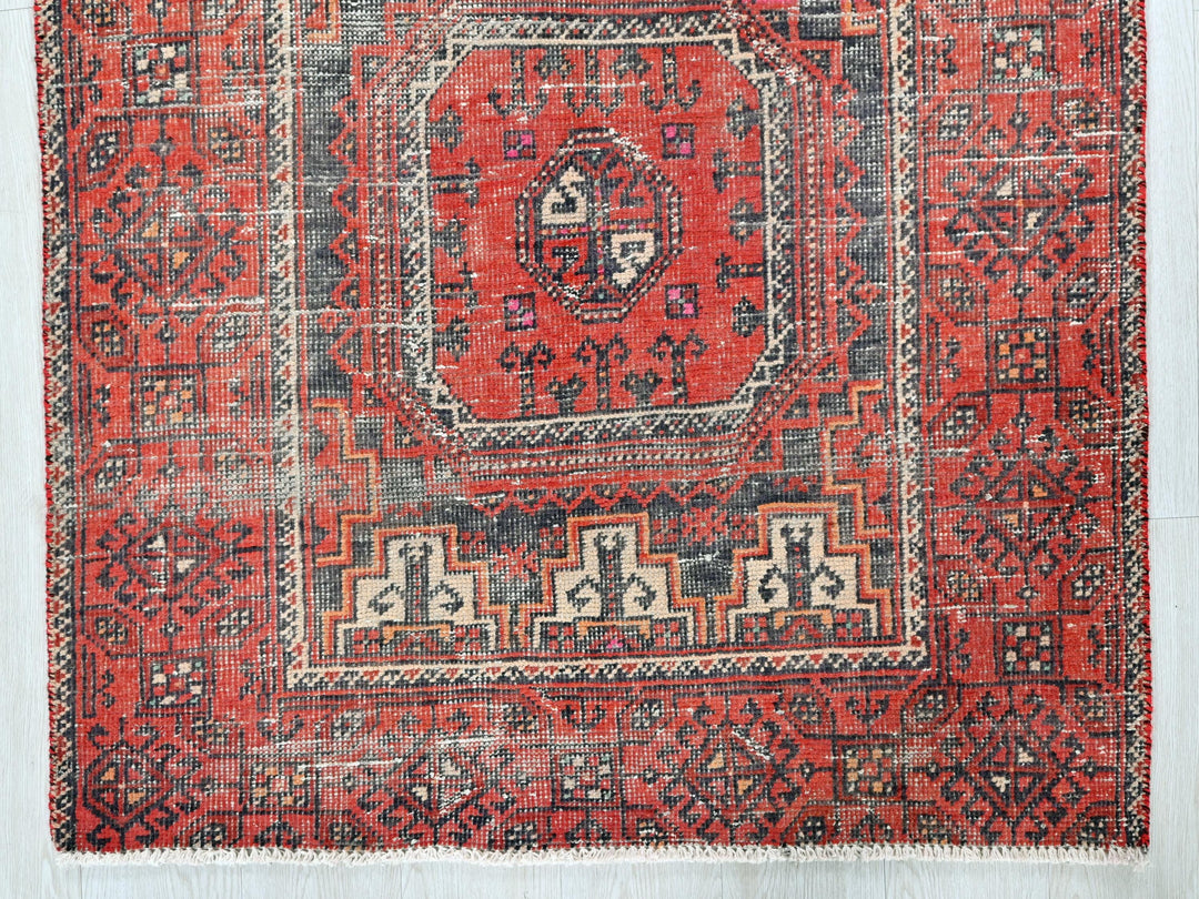 a red rug with an intricate design on it