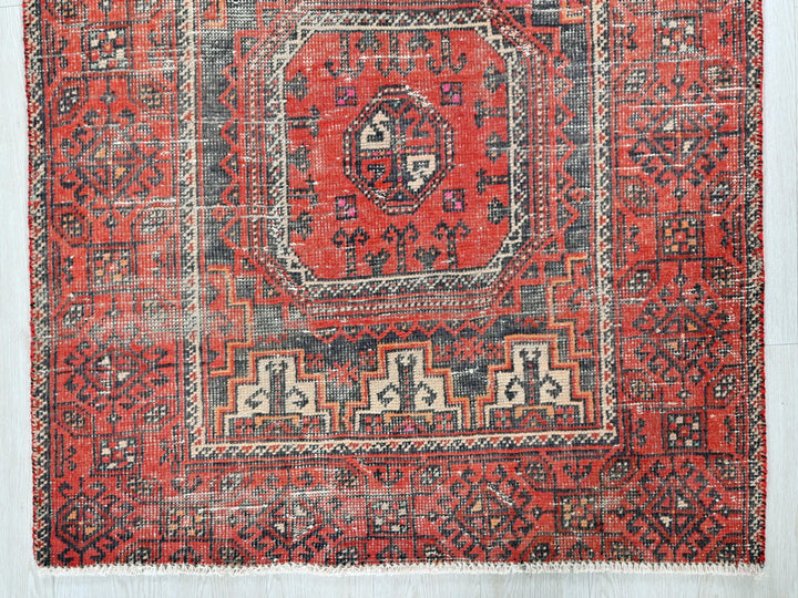 a red rug with an intricate design on it