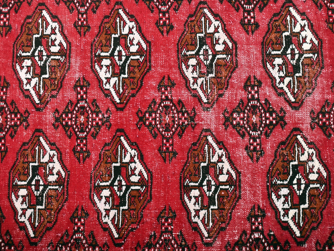 a close up of a red rug with a pattern on it