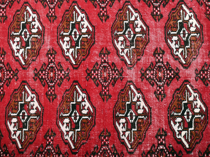 a close up of a red rug with a pattern on it