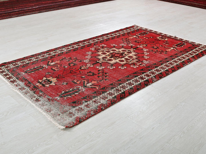a red rug on the floor of a room