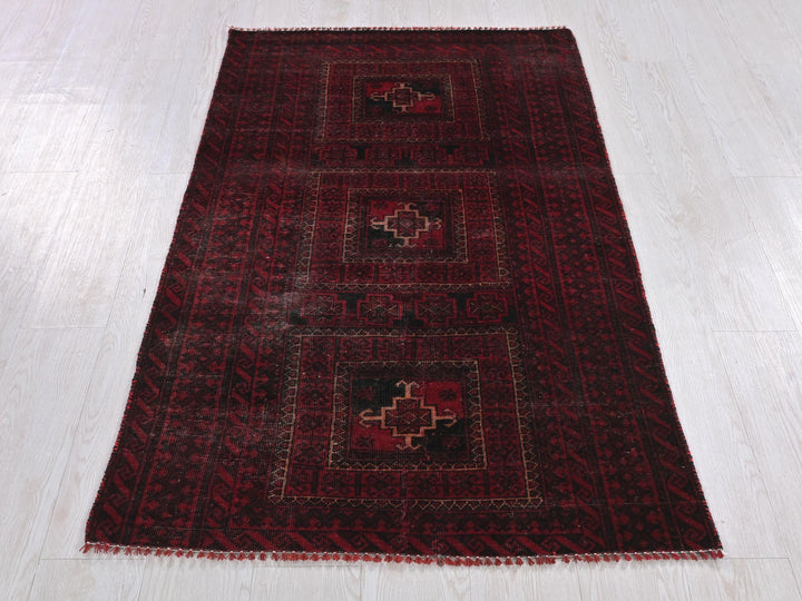 a red rug on a wooden floor with a white floor