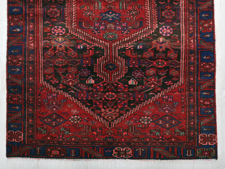 a red rug with a blue and red design on it