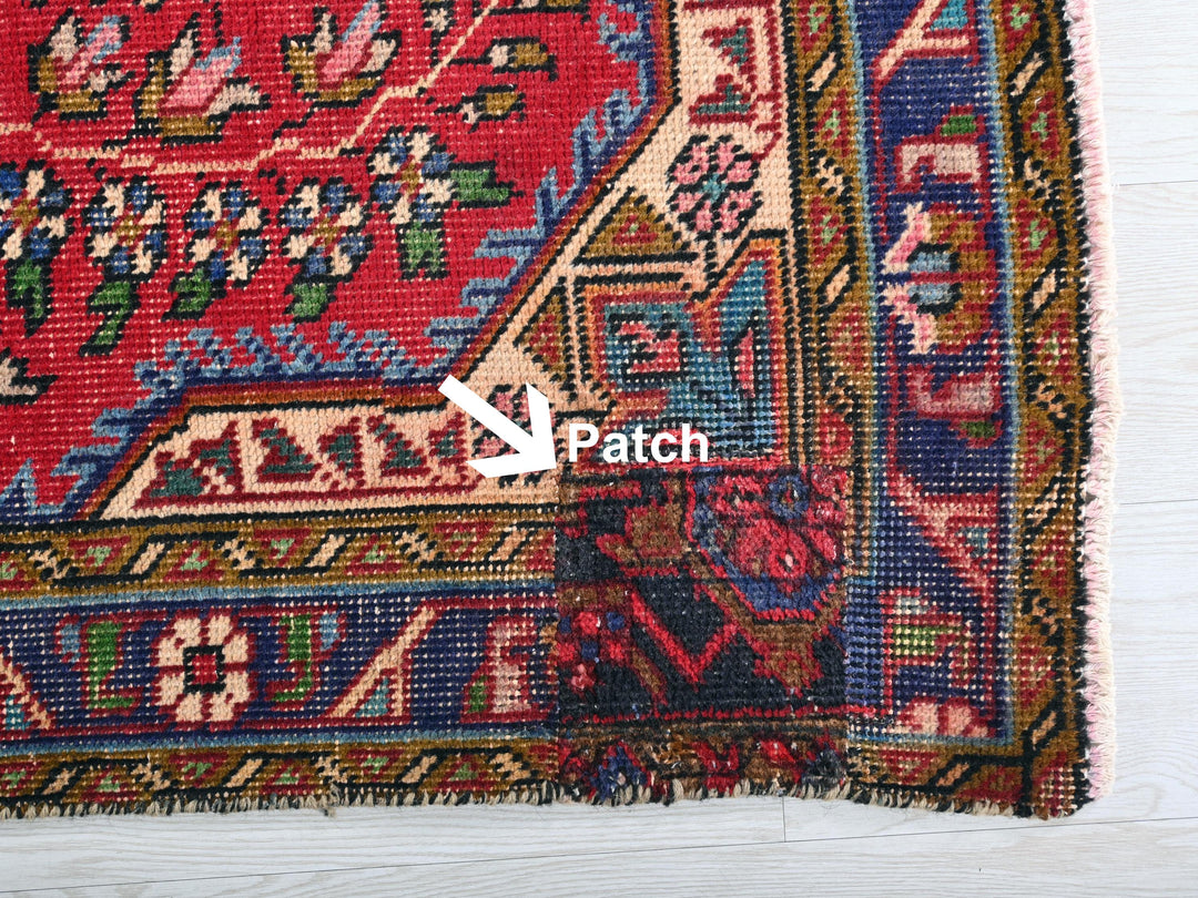 a close up of a rug with a patch in the middle