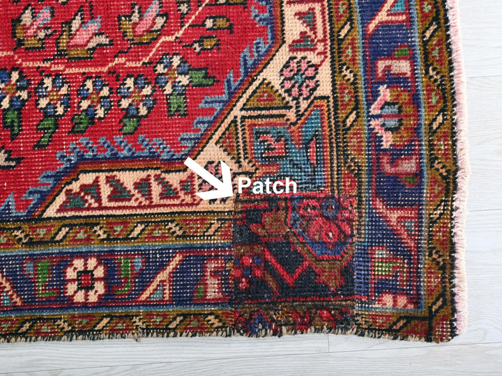 a close up of a rug with a patch in the middle